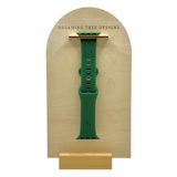 a green watch on a wooden stand