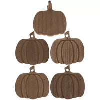 three wooden pumpkins hanging from a hook