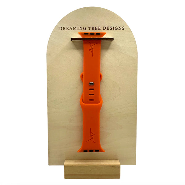 an orange wrist watch on a wooden stand